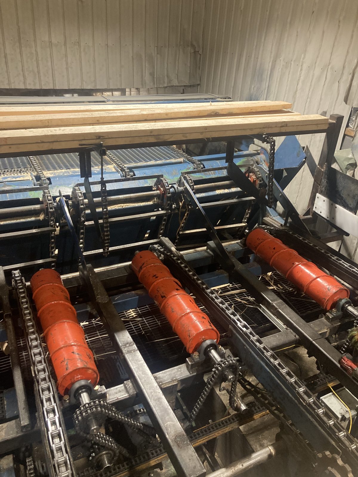 Overview of sawmill drag chain conveyor with new centering rollers and chain drive system — Opitciwan sawmill, Mauricie, Quebec